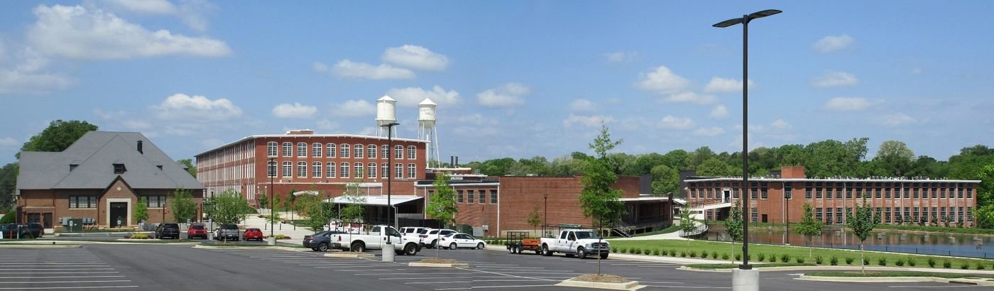 Drayton Mill in Spartanburg: the red-brick mill building and its twin water towers under a blue sky